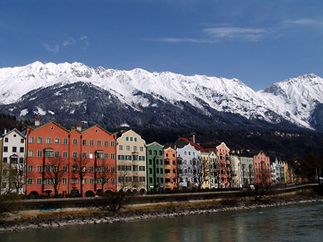 row of houses in mariahilf with snowy mountain background 