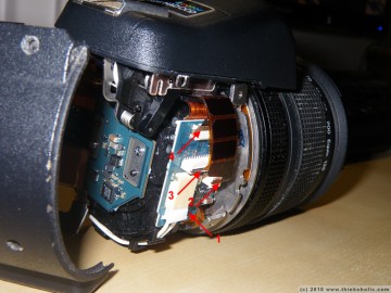 step 5: when you remove the white power connector from its shoe (1), your lens is completely disconnected from the rest of the body. if you plan to remove the flash, disconnect the three ribbon cables (2-4).