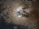 the moon and jupiter, halfway masked by clouds