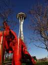 space needle and orange art thingy (olympic iliad). 2006-02-10, Sony DSC-F717. keywords: blue, white