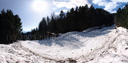 panorama: avalanche field and hikers for scale