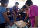 local women playing domino on the boat to manado