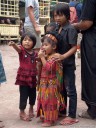 kids are watching the processing of the water buffalo.