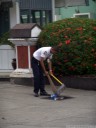 a security guy is getting rid of some trash. through the drain.. 2011-09-24 07:35:51, DSC-F828. keywords: gulli, abfluss