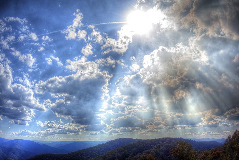 dramatic clouds, sun rays, and rolling hills above giro and the monkeycot nature reserve