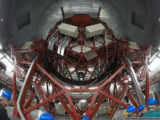 the gran telescopio canarias from behind, showing the back of the primary mirror construction and looking through to the secondary mirror (lower centre)